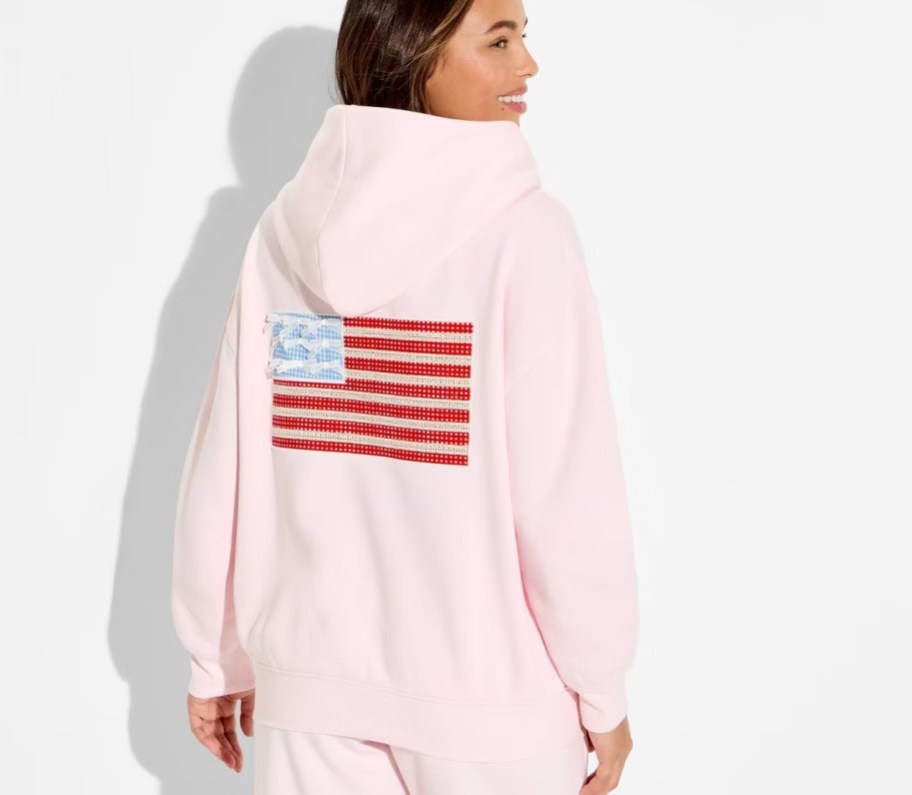 Woman modeling pink American flag hoodie