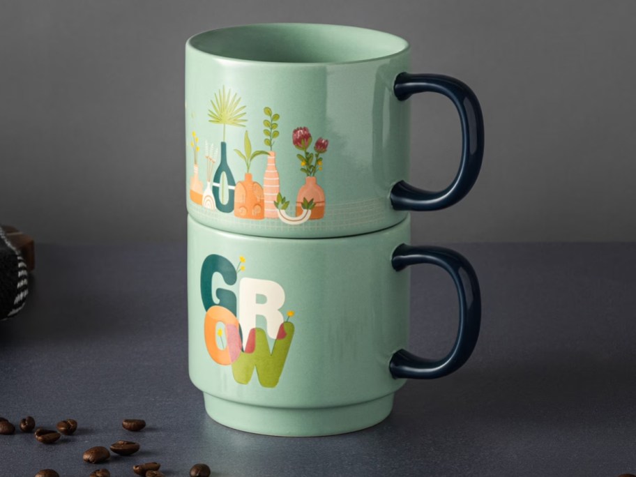 two green garden mugs on table