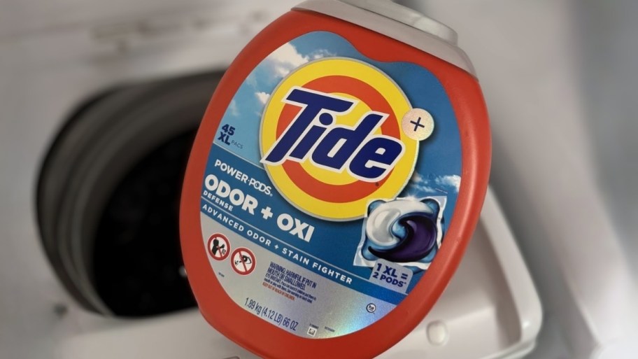 tide XL 45 count pods container in front of a washing machine
