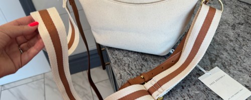 hand grabbing light canvas bag