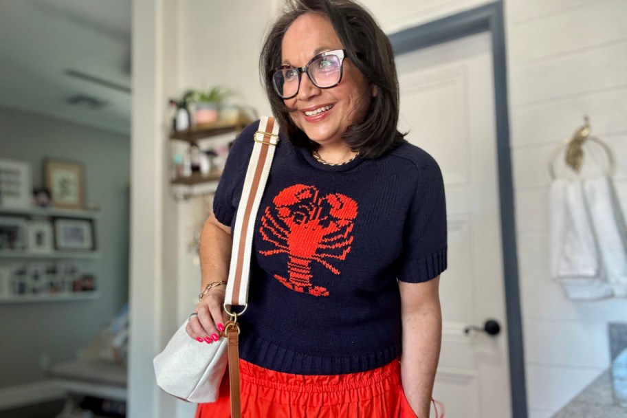 woman wearing blue top with red lobster on it