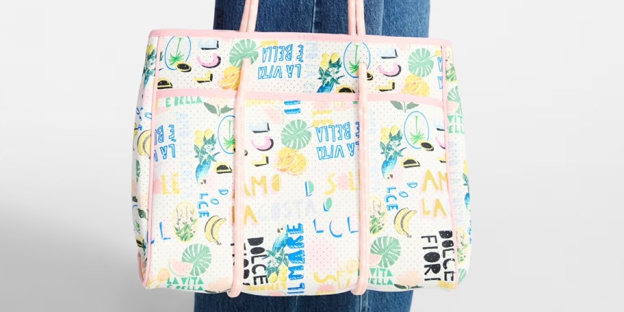 person holding pink beach tote 