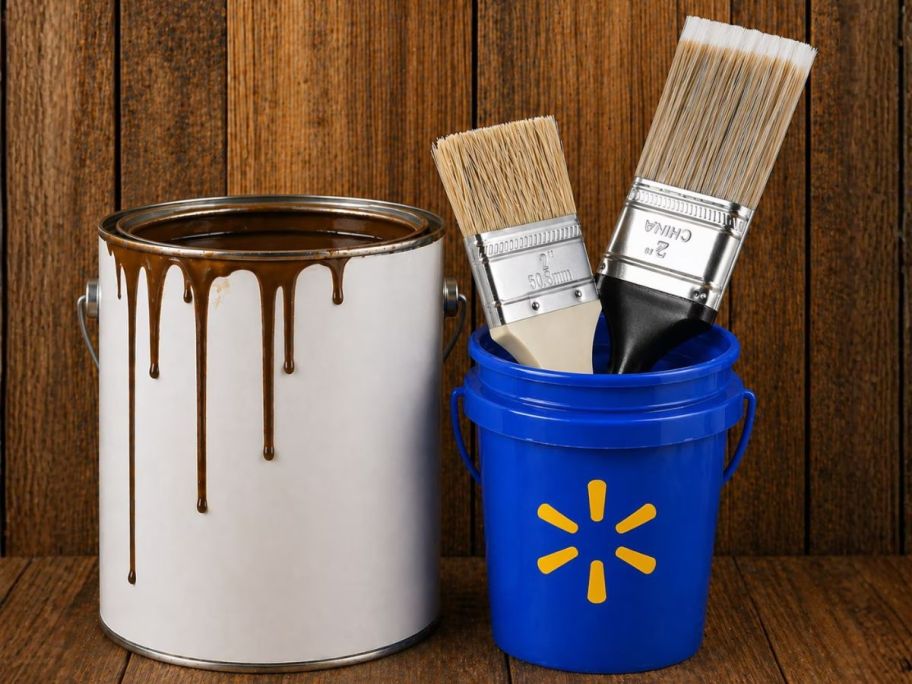 walmart mini bucket next to paint can with paintbrushes in it