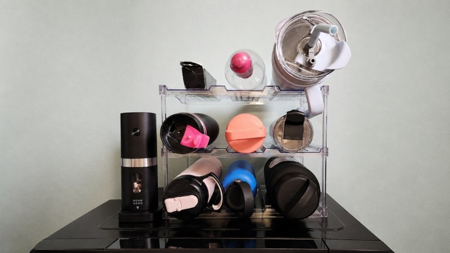 a 3 tier water bottle organizer on a tabletop