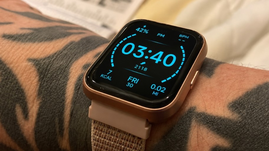 a womans wrist shown wearing a smart watch