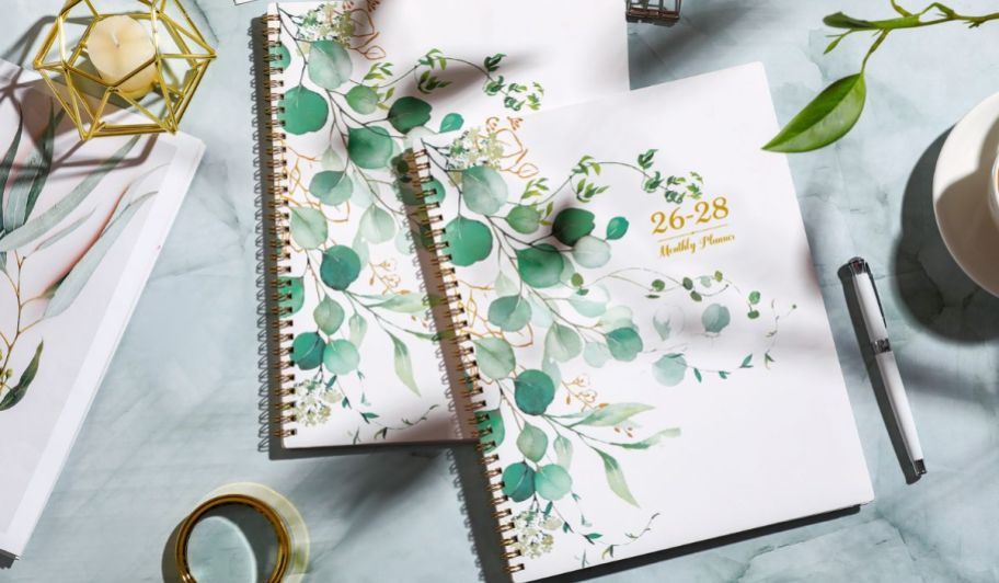 two floral planners on top of a table