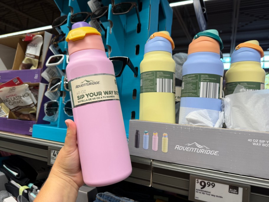 hand holding pink water bottle