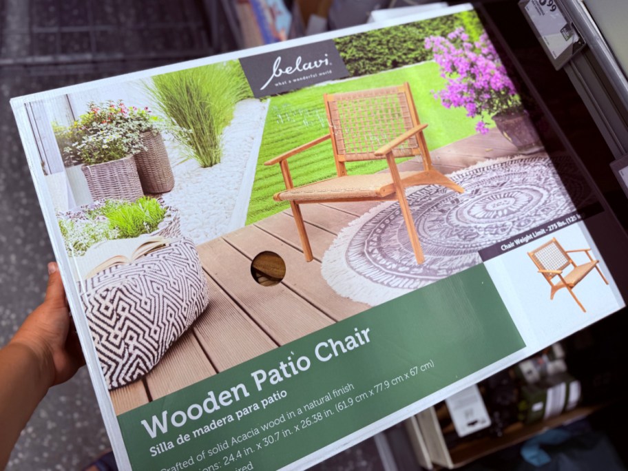 hand holding wooden chair in box