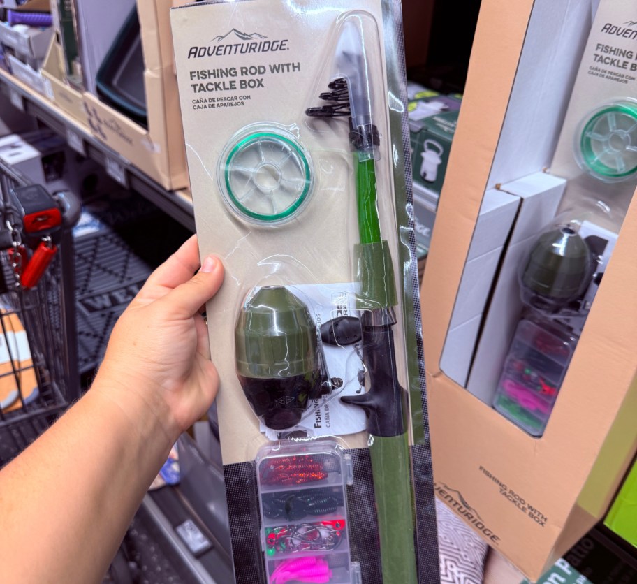 hand holding fishing rod in store