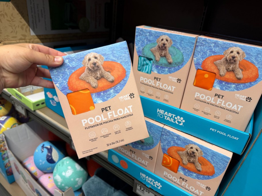 hand holding pet float box near shelf