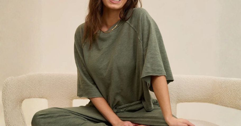 woman wearing green Aerie It's Casual Knit Slub T-Shirt while sitting on couch