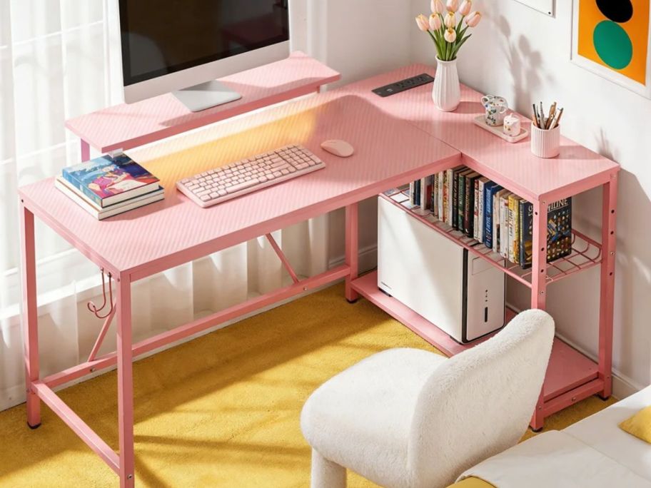 A pink l-shaped corner gaming desk
