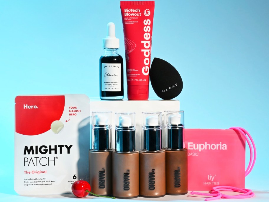 various beauty products stacked around a white box