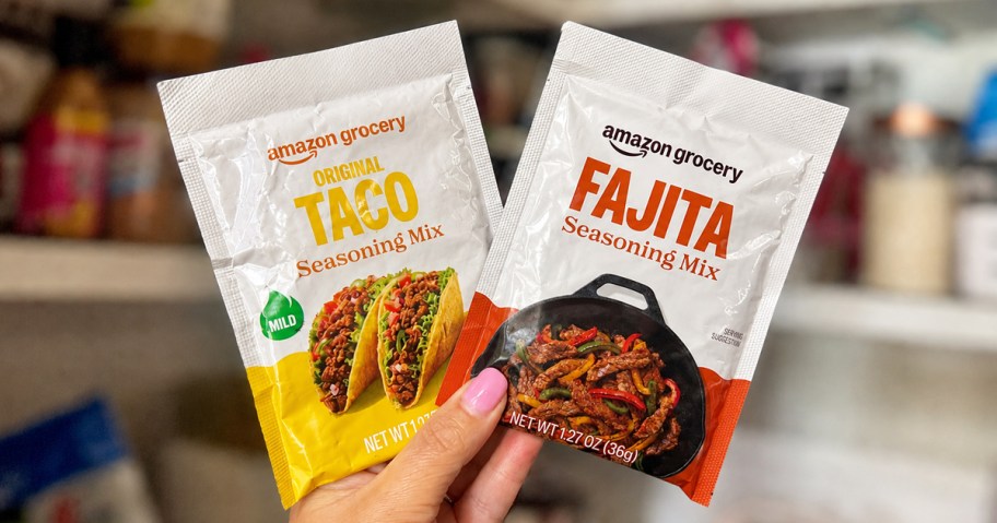 hand holding up two taco and fajita seasoning packets