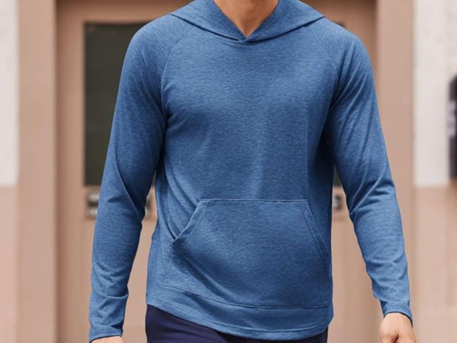 man wearing blue long-sleeve Amazon hoodie