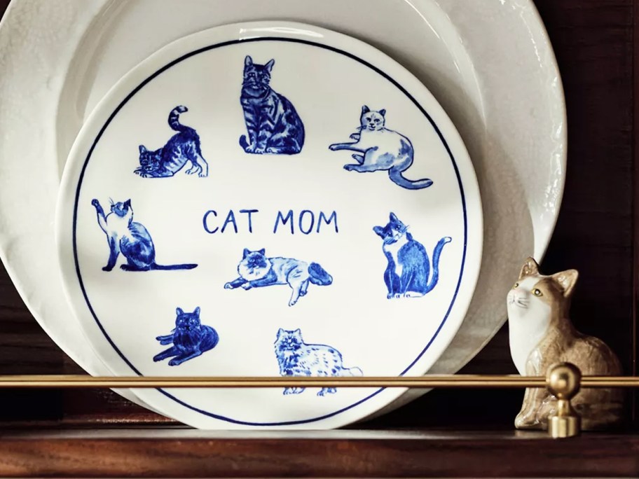 white and blue cat mom plate on a shelf