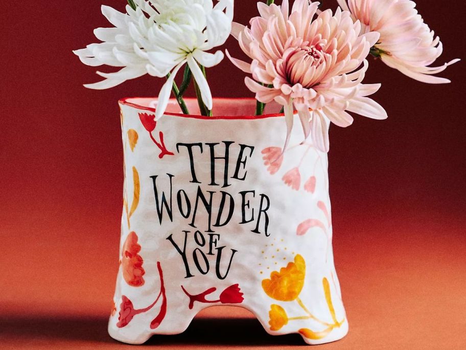 An vase with flowers that says The Wonder of You on it