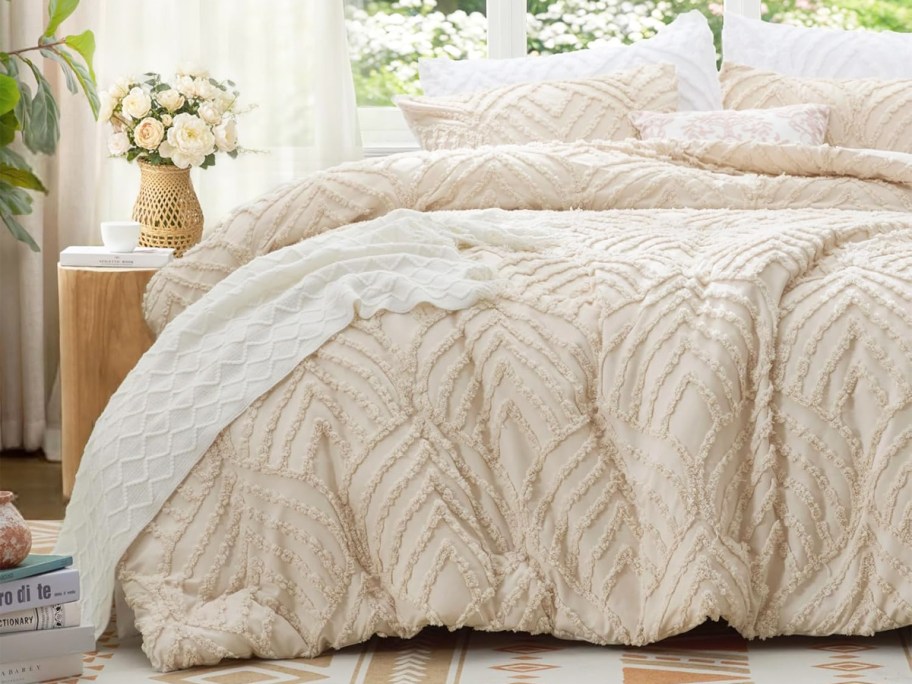 cream comforter set on a bed with white sheets