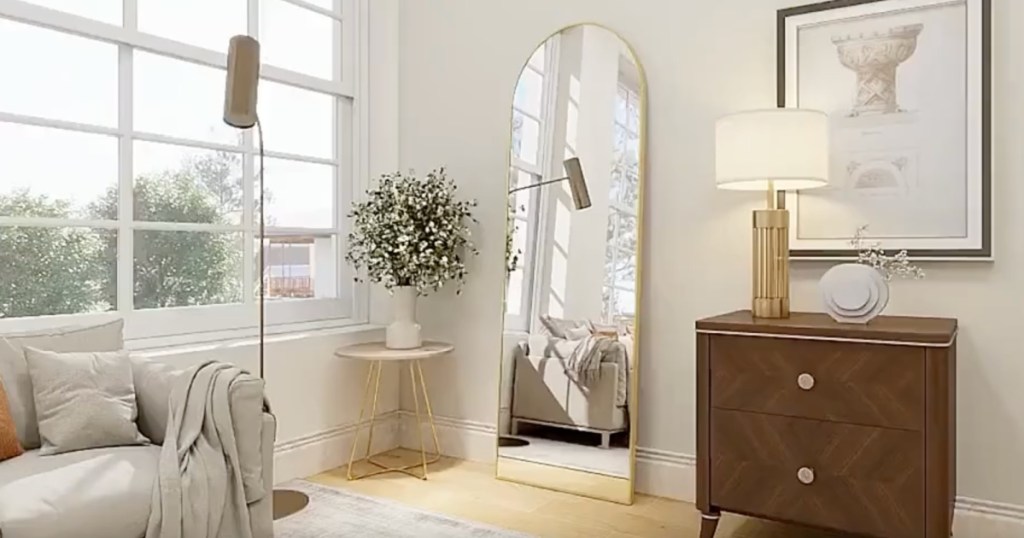 gold arched mirror in living room