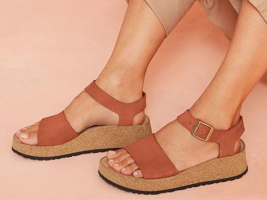 woman's feet wearing Papillio by Birkenstock Glenda Leather Wedge Sandals in Pecan color