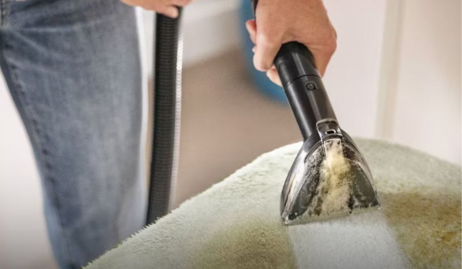 hand holding Bissell pet vacuum handle