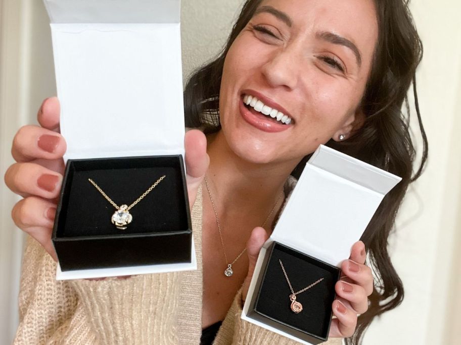 Woman wearing a Cate & Chloe Alessandra Necklace while holding two more in Cate & Chloe Gif Boxes