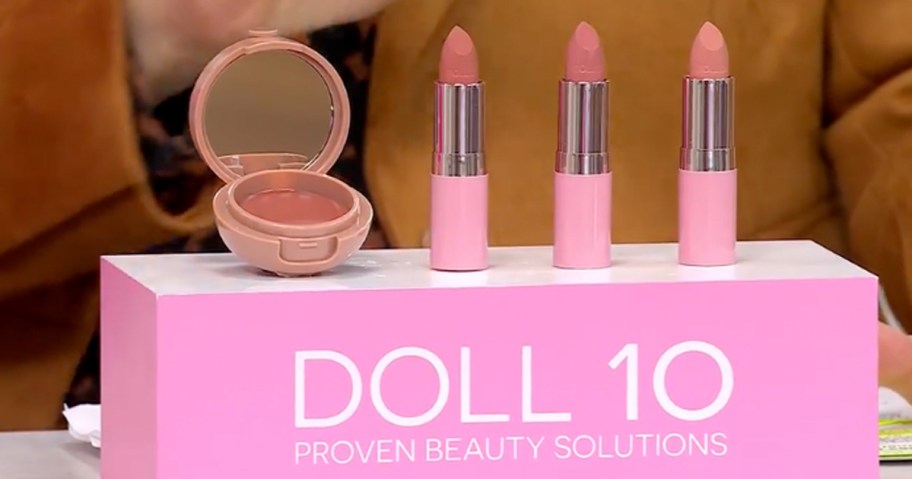 three lipsticks and a lip balm on display