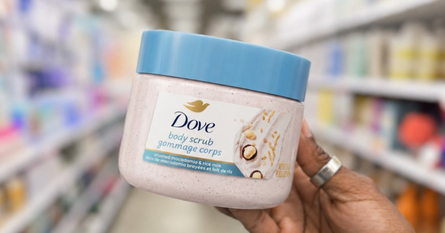 hand holding up a jar of Dove Body Scrub in store