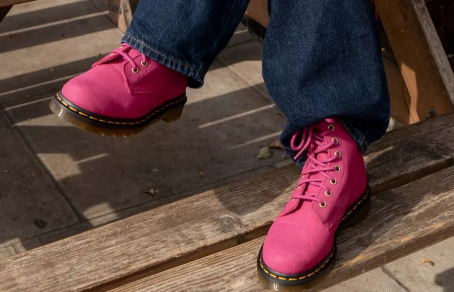 person in jeans with pink boots