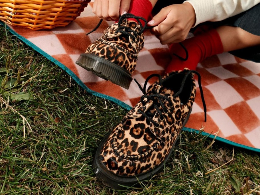 person putting on leopard print shoes