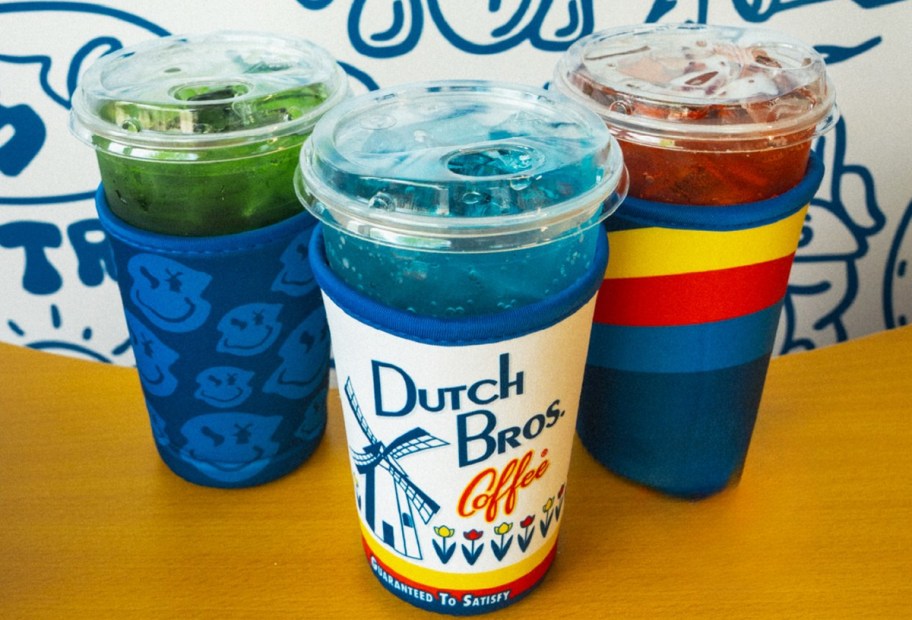 three iced drinks with Dutch Bros coffee sleeves