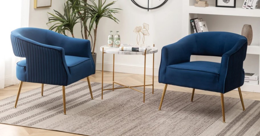 two blue velvet chairs in a living room