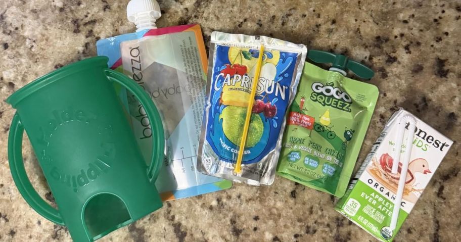 a flipping holder with different types of food and juice pouches next to it
