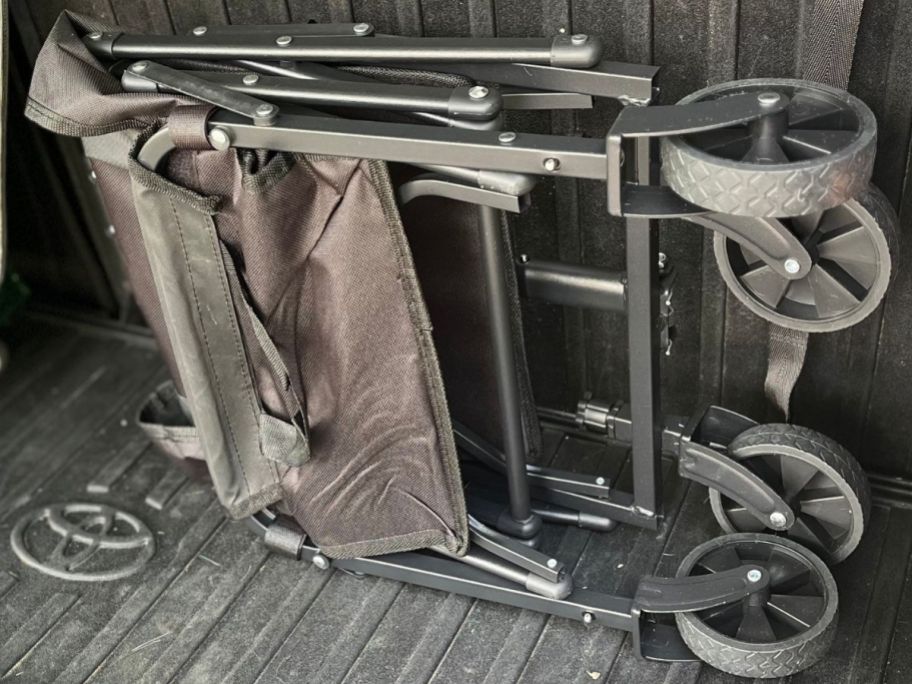 A folding wagon folded in the back onf a vehicle