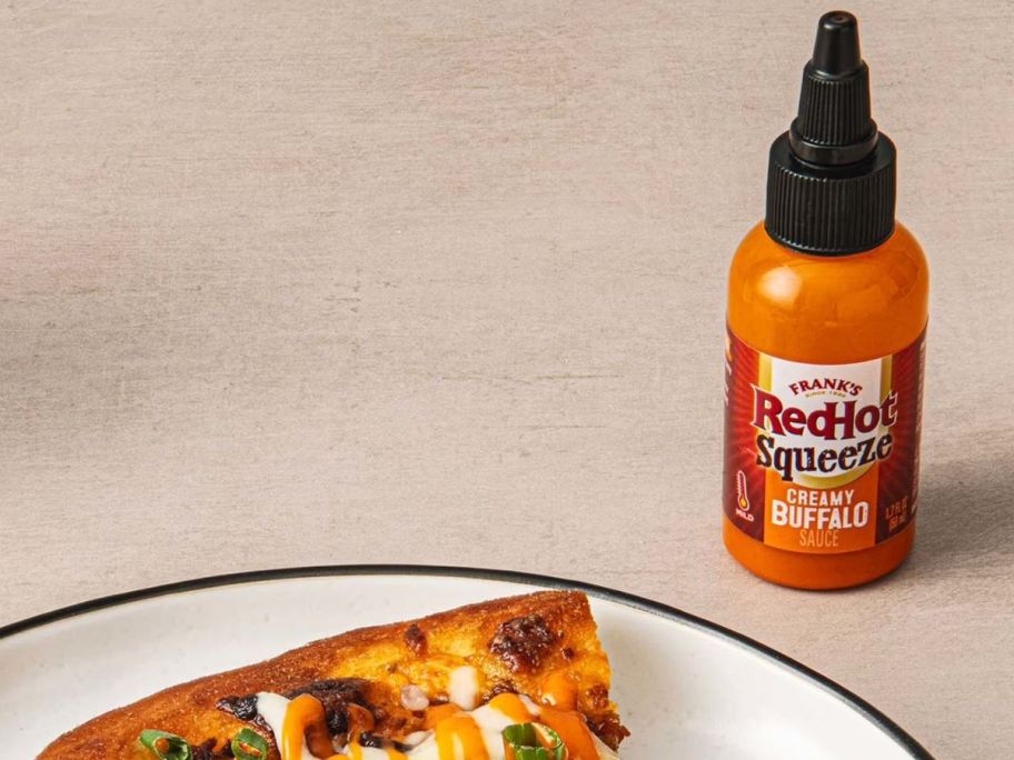 Frank's RedHot Creamy Buffalo Mini Sauce next to pizza