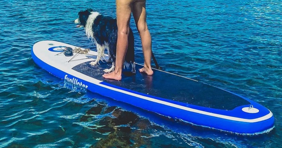woman and dog on a blue inflatable paddle board