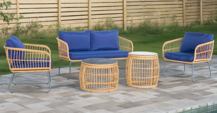 wicker patio set with blue cushions and 2 coffee tables