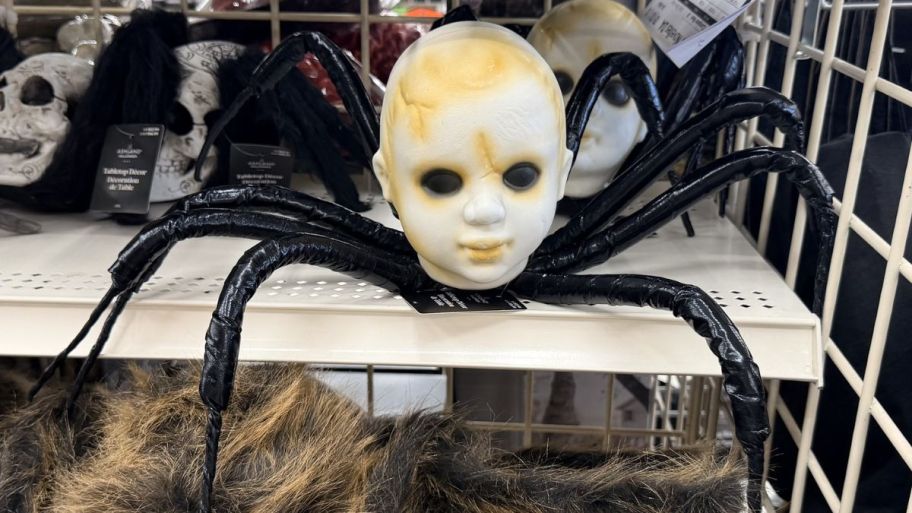 Halloween baby head spider on top of a shelf
