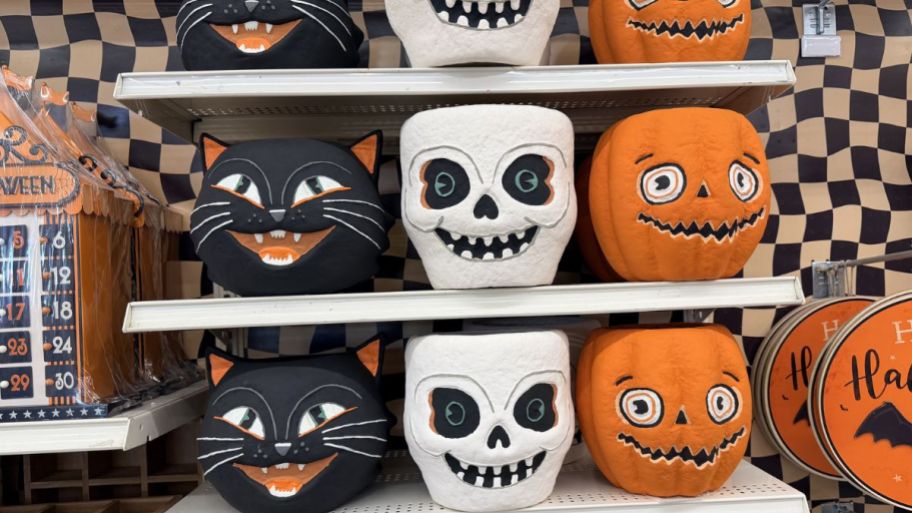 Three different vintage paper mache candy baskets on the shelf