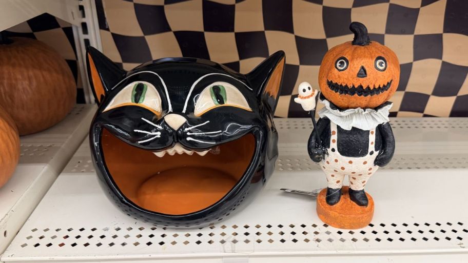Halloween tabby cat bowl and jester displayed on a shelf