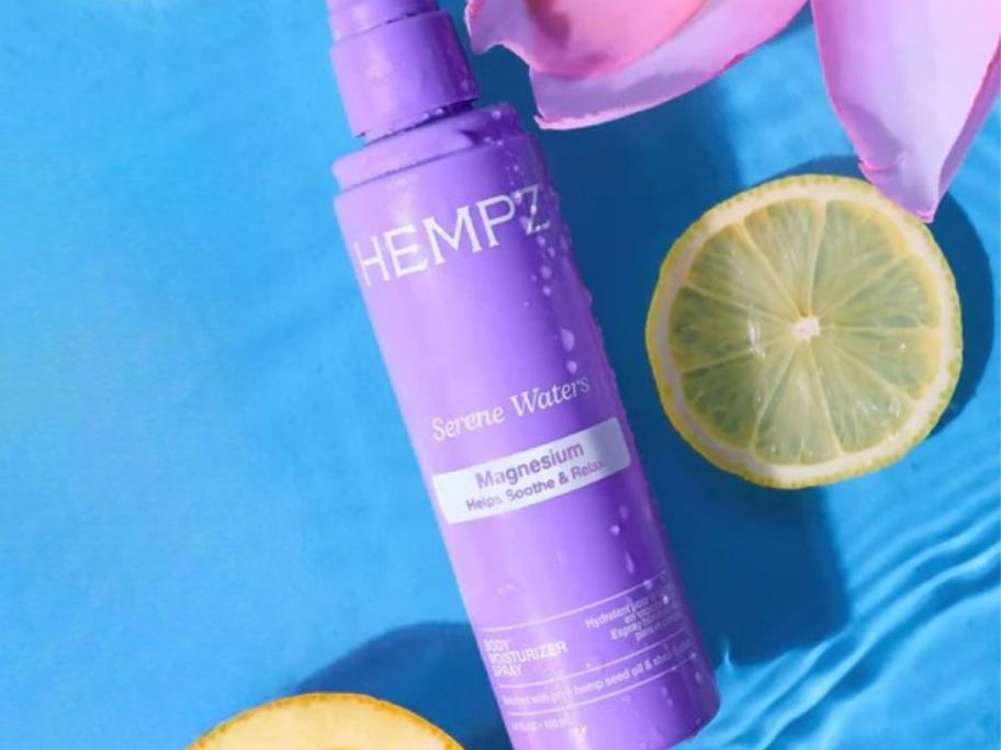 Hempz Magnesium Body Spray 3.4oz bottle nect to lemons and flowers