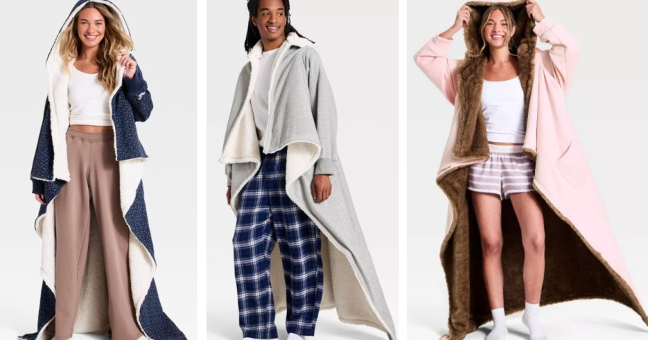 Man and woman wearing long Hollister hooded blankets in different colors