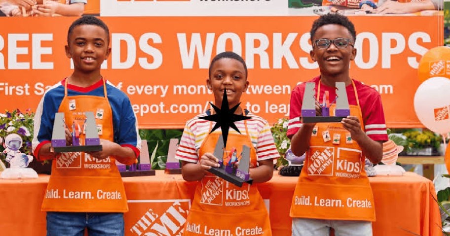 Kids at Home Depot holding up crafts