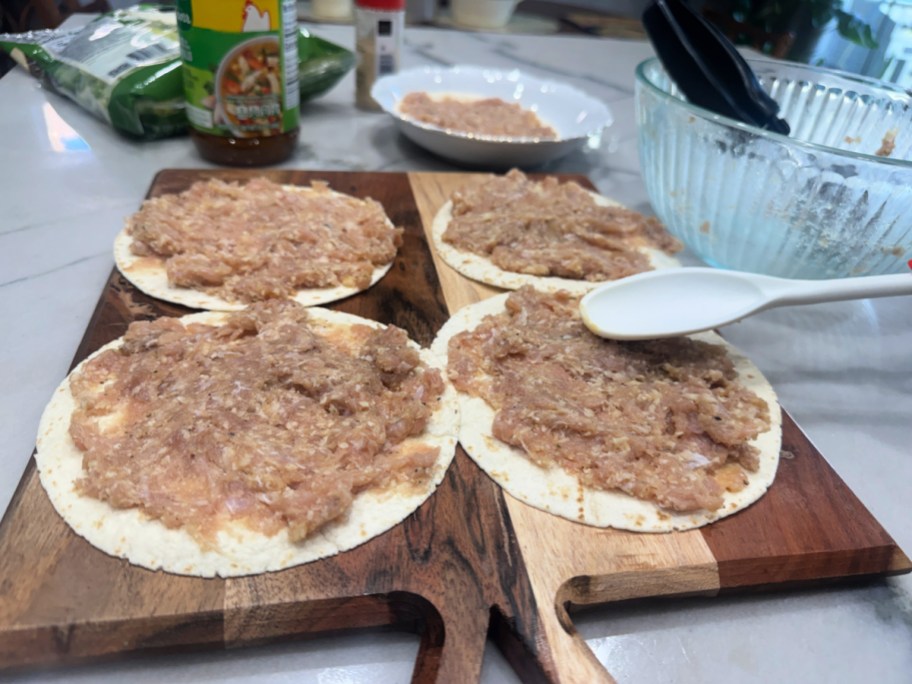 smashing chicken onto tortillas