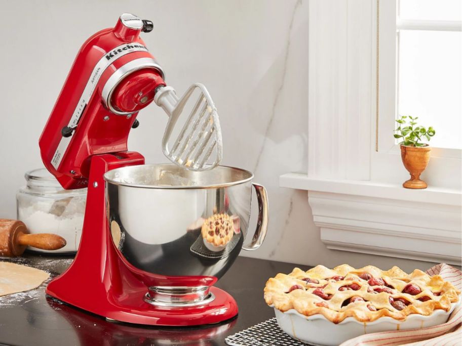 KitchenAid 5-qt Artisan Stand Mixer w/ Pastry Beater & Flex Edge next to pie on counter