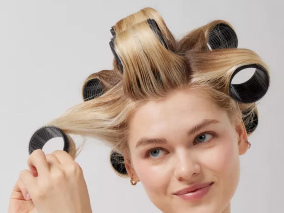 woman wearing kitsch hair rollers in blonde hair