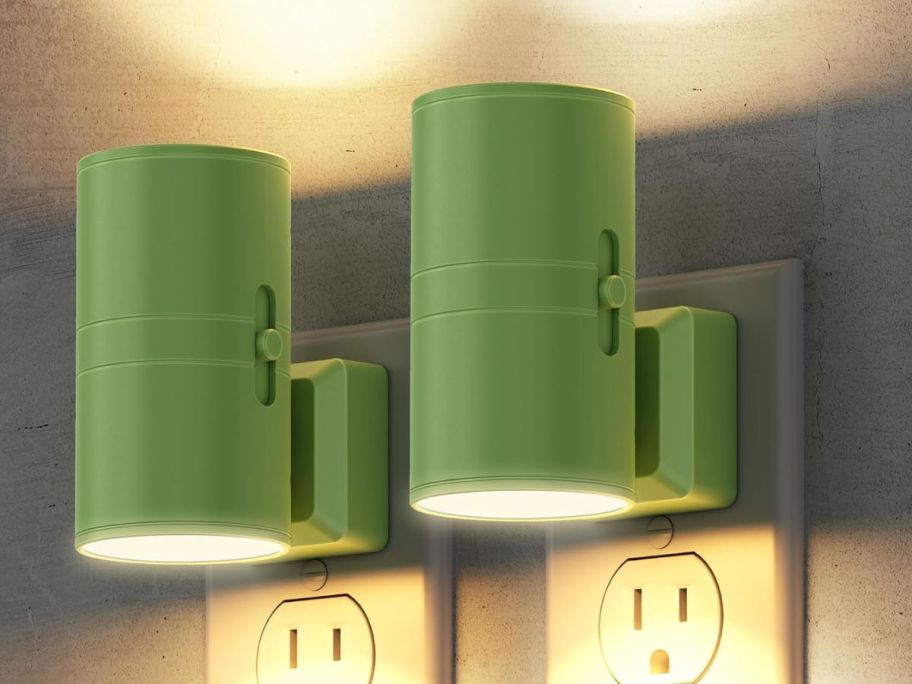 Two green LED nightlights plugged into outlets