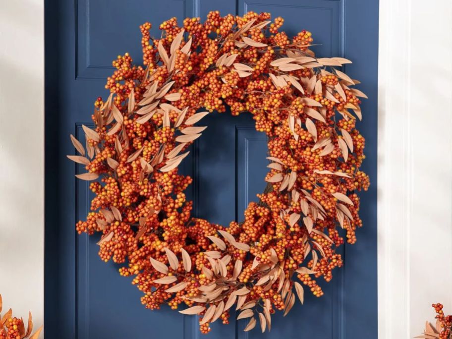 Large fall wreath with berries displayed on the walls