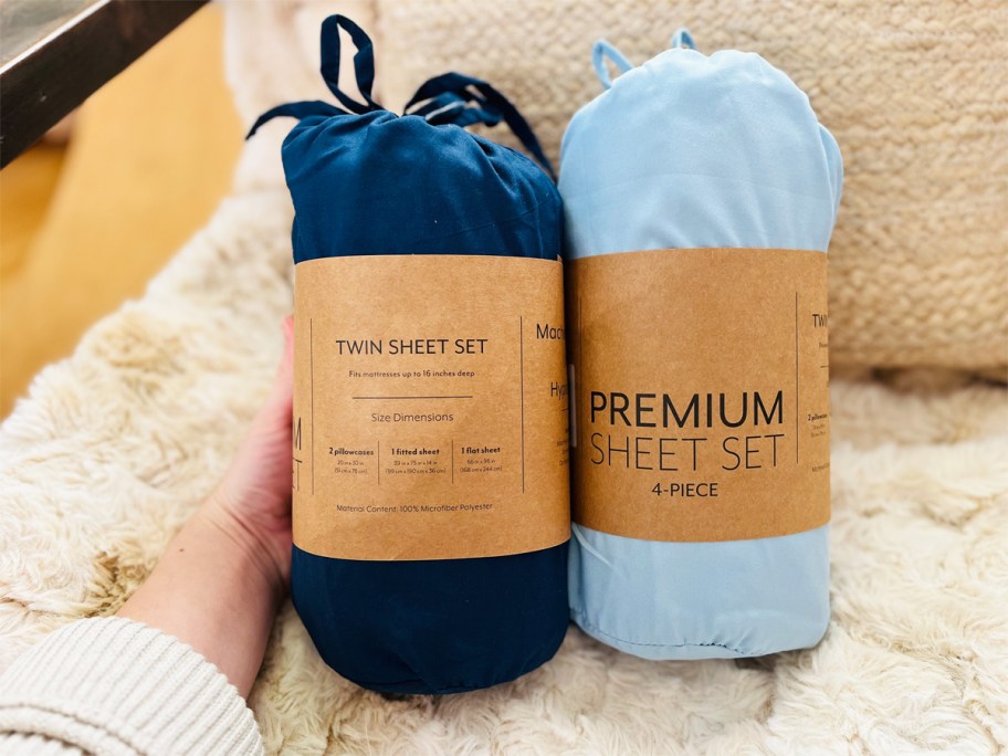 hand touching dark and light blue sheet sets