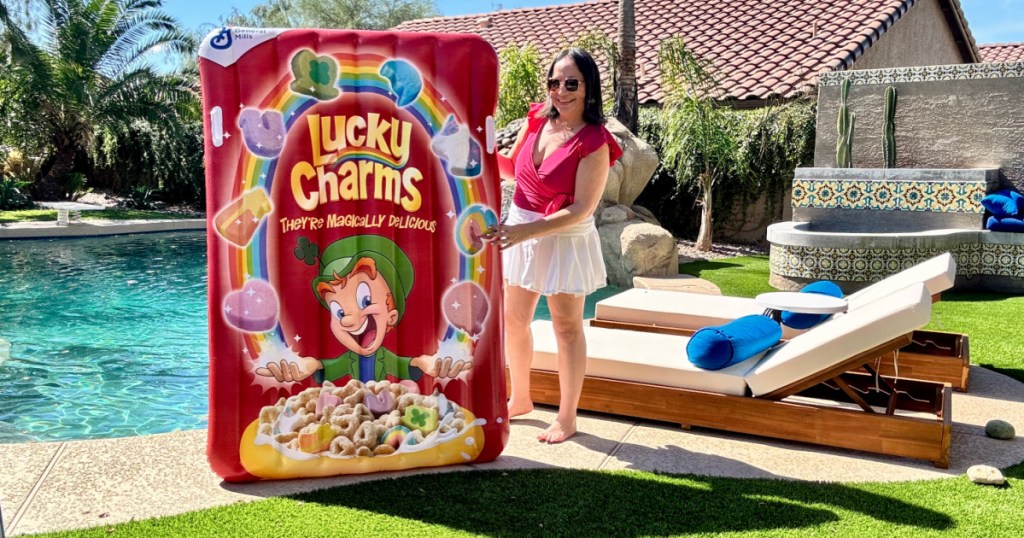 Woman holding up lucky charms pool flow in backyard next to pool